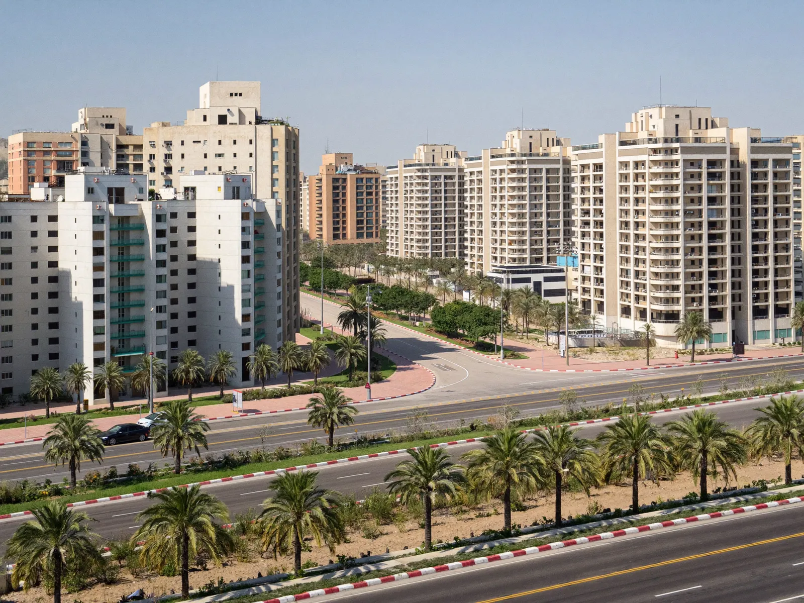 Residential apartment blocks along a wide road in Dubai Production City