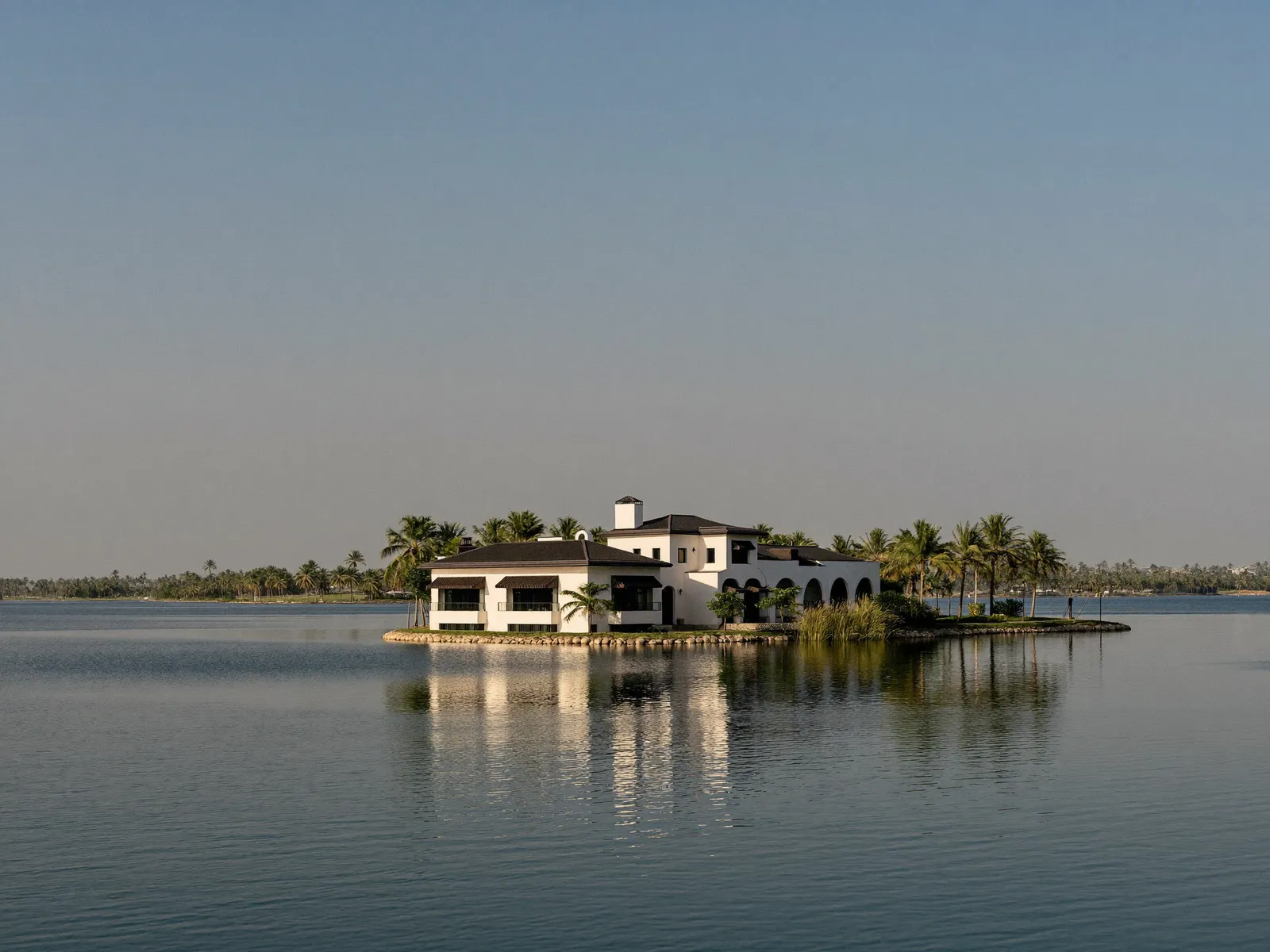 Waterfront villa surrounded by lake water and palm trees in Jumeirah Islands