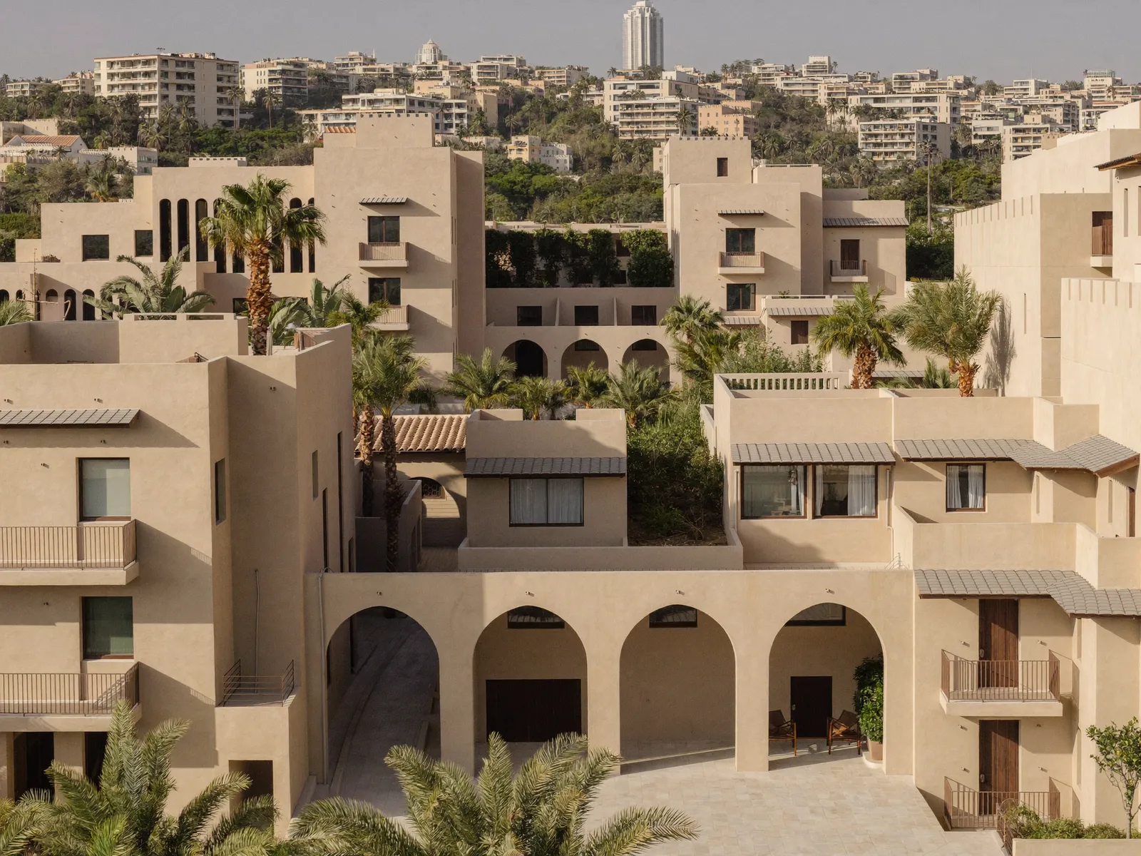 Low-rise beige apartment buildings with arches and courtyards in Remraam